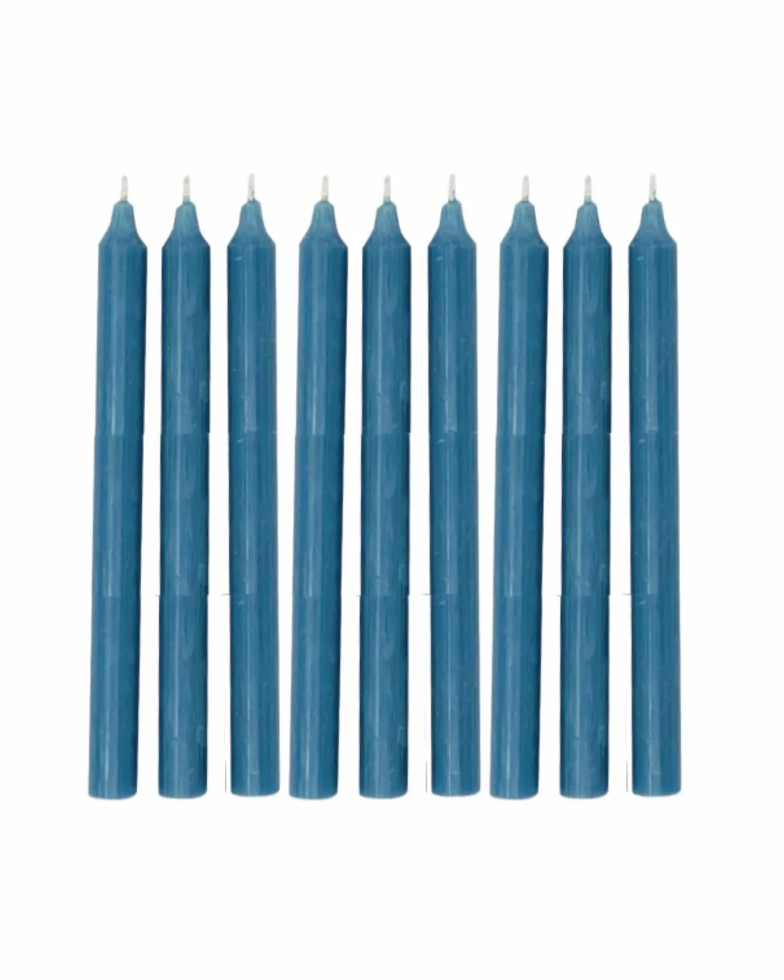 A single dusty blue dinner candle standing upright, photographed against a plain background.