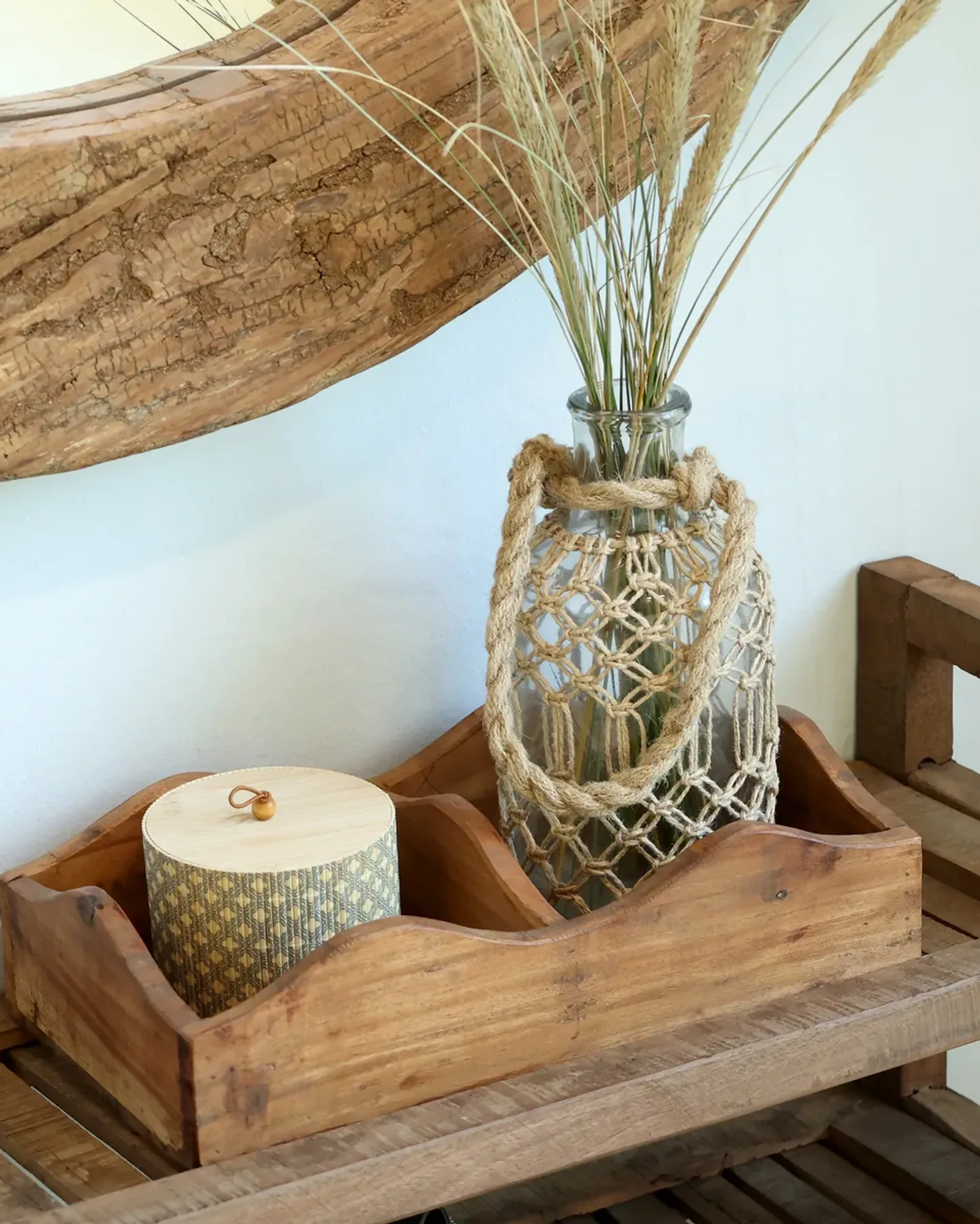 A natural recycled-wood box with a central divider and scalloped ends, holding a lidded jar and a rope-covered bottle.