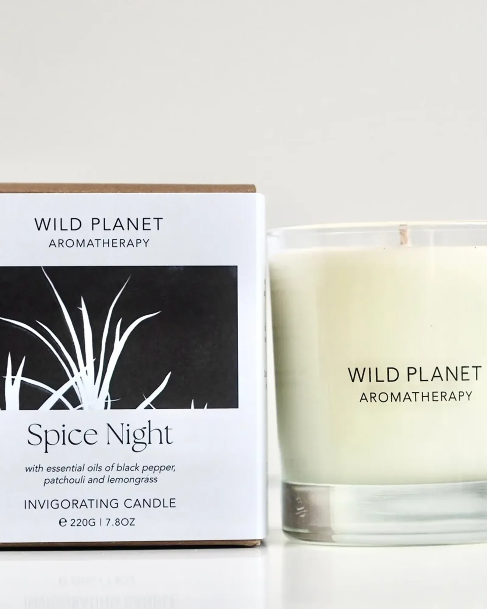 A Spice Night scented candle: soy wax with a single wick in a clear glass tumbler, beside its card box printed with the scent's name.