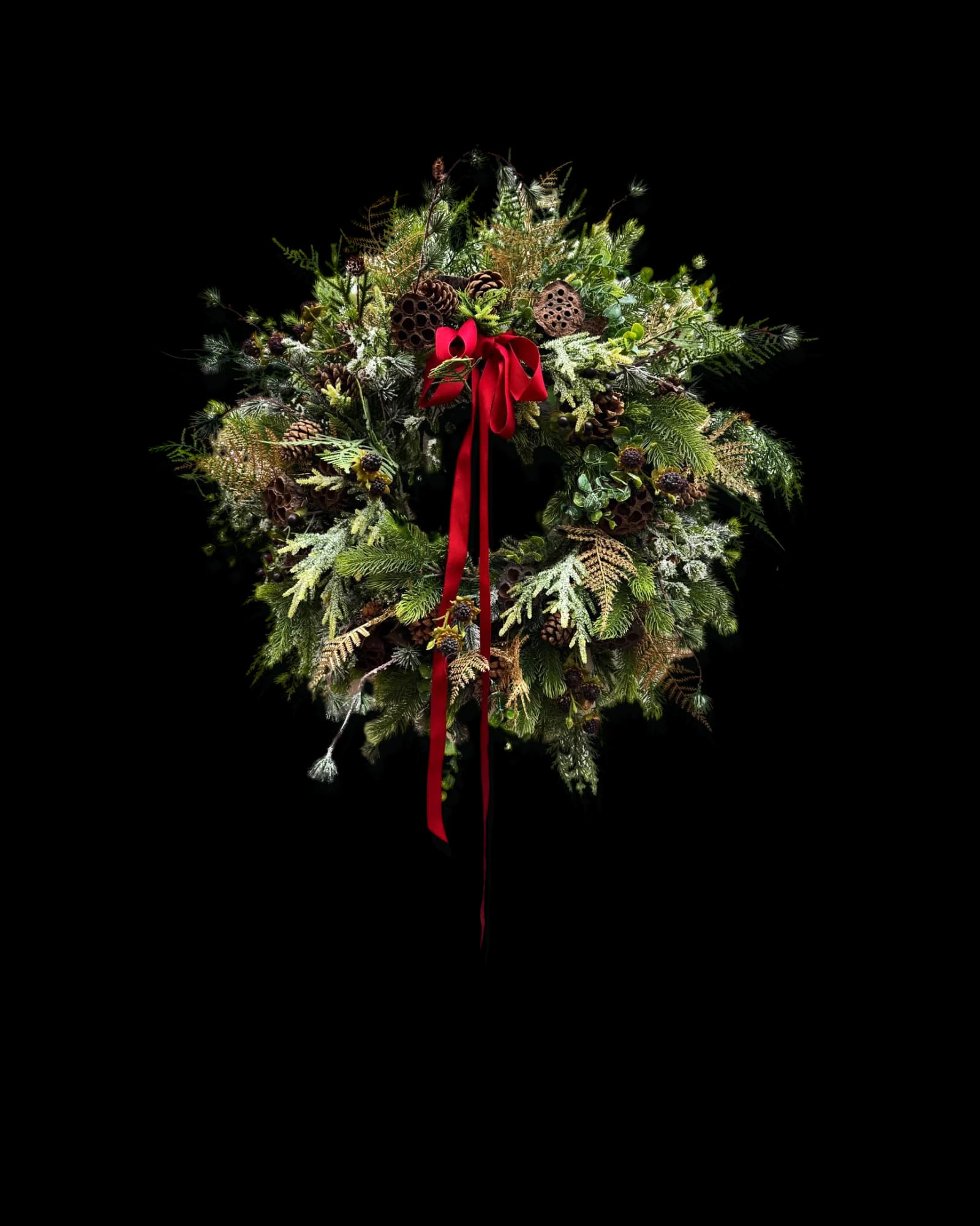 The everlasting Christmas wreath with a red velvet ribbon